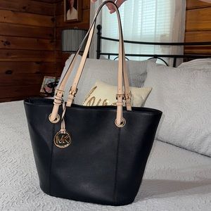 Lovely Michael Kors black purse. A lot of pockets and zipped interior.